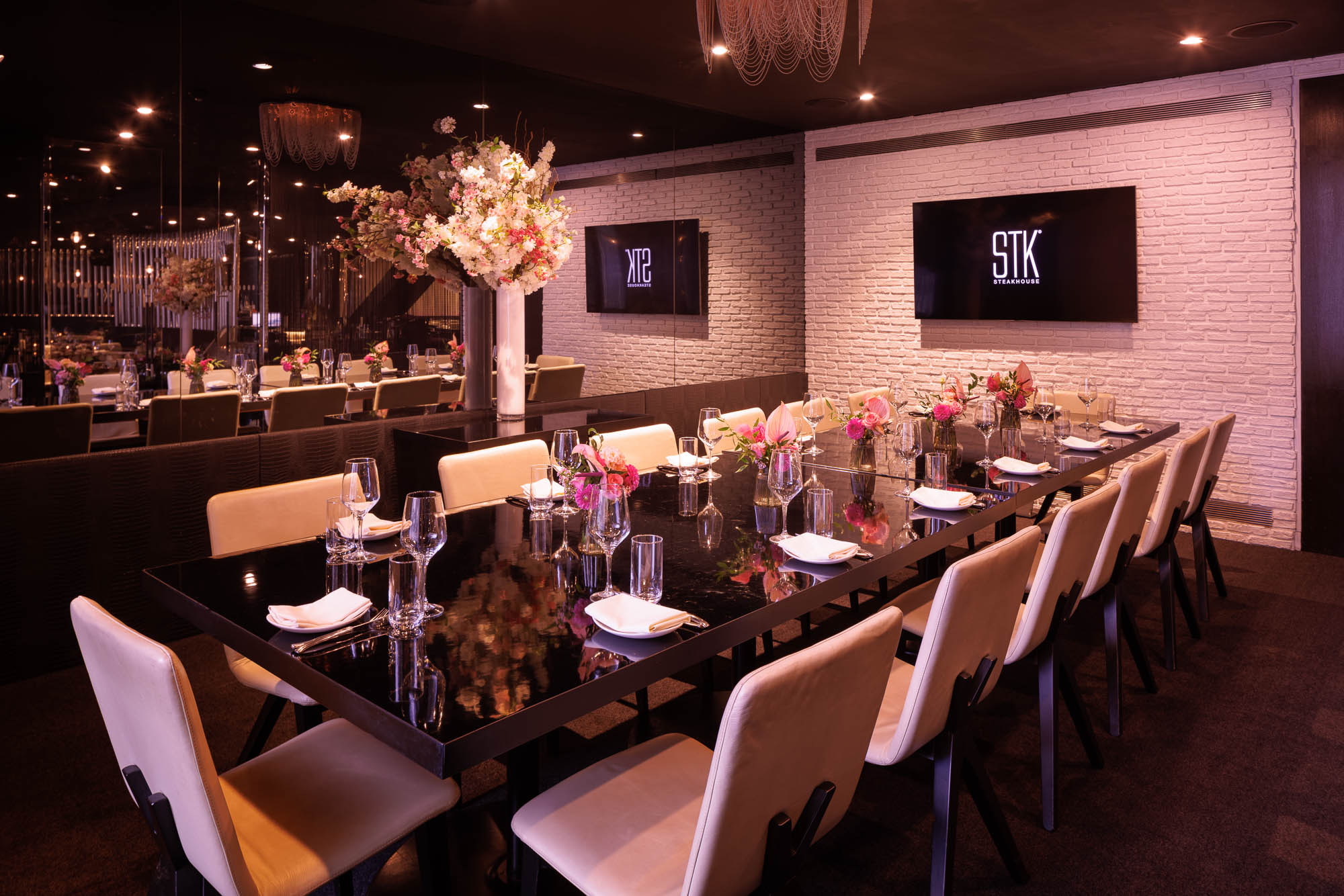 An interior shot of a long table at STK Strand